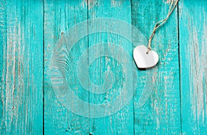 Old turquoise wooden floor with a white wooden heart