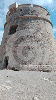 Old turrets built on high promontories on the sea to spot pirates and other boats and ships on the coast of ibiza