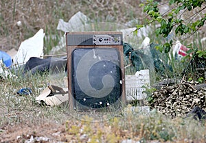 Old TV  thrown into a landfill.