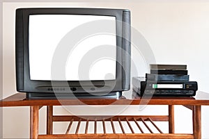 Old TV with VCR on the background of wallpaper.Retro technology concept. Blank screen for text.