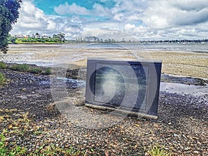 An old tv washed ashore after heavy rain photo