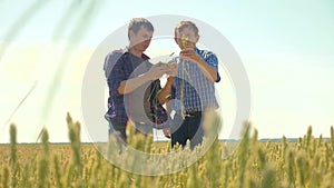 Old two farmers summer handshake man on your smartphone Wheat Field running in the field wheat bread. slow motion video