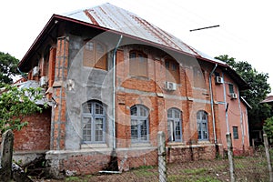 Old two storey brick house, and wooden window.