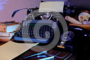 Old typewriter on desk, telephone, mystery detective concept, writer`s work tools, blue backlight