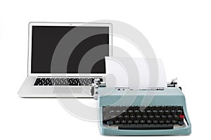 Old typewriter in front of contemporary laptop