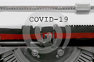 Old typewriter with the inscription Covid-19