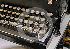 Old typewriter keyboard close up with circular keys with alphabet letters