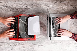 Old typewriter and laptop on table. Concept of technology progress