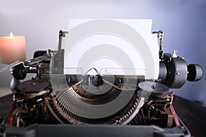 Old typewriter on table, blank white sheet for text, mockup, retro style, concept of works of a writer, journalist