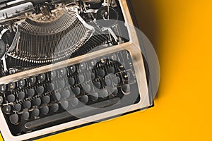 Old Typewriter On A Yellow Background, Top View. Creative Journalism Concept