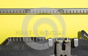 Old typewriter with yellow paper Merry Christmas