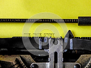 Old typewriter and yellow paper with text true story