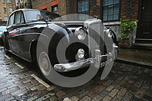 Old typical brick house in Shoreditch London with Bentley vintage car