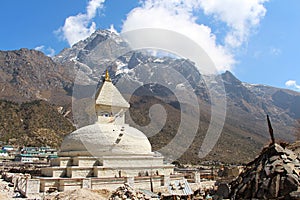 Old typical white Buddhist stupa at the foot of mountain in Nepal