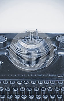 Old typing machine and blank sheet of paper for your text, cyano style