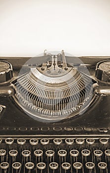 Old typing machine and blank sheet of paper for your text, sepia