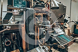 Old typography printing machine with letter samples.