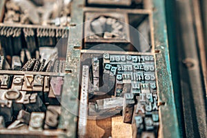 Old typography printing machine with letter samples.