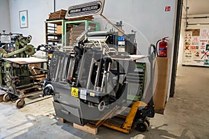 Old typography printing machine with letter samples.