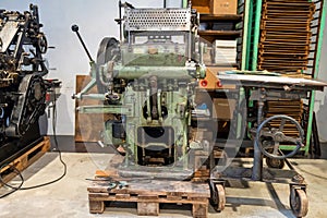 Old typography printing machine with letter samples.
