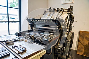 Old typography printing machine with letter samples.