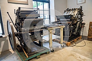 Old typography printing machine with letter samples.