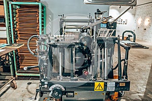 Old typography printing machine with letter samples.