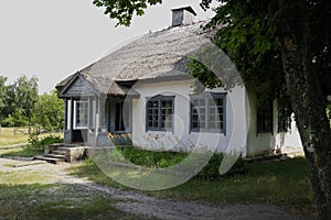 Old Ukrainian house. Ukrainian hut of the nineteenth century. Summer landscape, sunshine. Village Pirogovo.