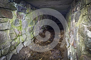 Old underground canal, water drainage system. Ancient underground passage, building