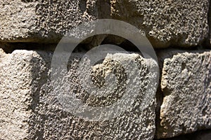 Old uneven crumbling brick, wall - background