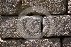 Old uneven crumbling brick, wall - background