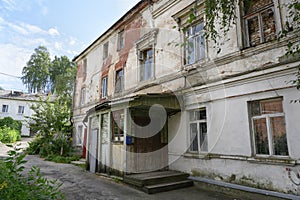 An old uninhabited peeling brick house in Kostroma, Russia