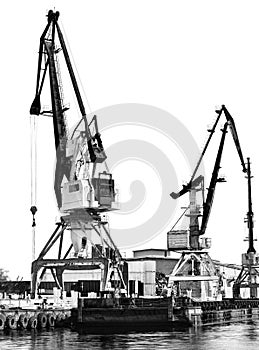 The old unloading cranes at the port. Contrasting black-and-white