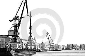 The old unloading cranes at the port. Contrasting black-and-white photo