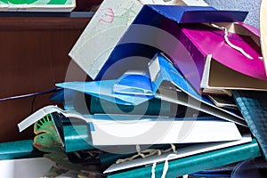 folders binder with documents in a mess lie on the shelf