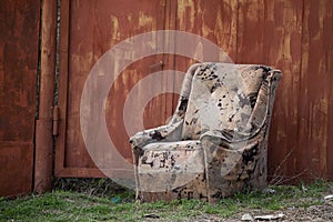 old unnecessary easy chair thrown out into the street