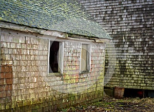 An old unsafe lobster fishing dock house on the verge of collapse