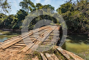 Old unsafe wooden bridge without railing in the wilderness of Paraguay.