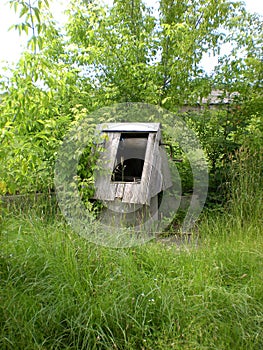 Old, unused and broken wooden well photo
