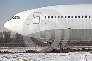 Old unused large passenger plane on a snowy field, will be turned into a museum piece. Decommissioned aircraft
