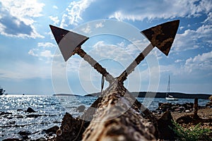 Old unused rusty anchor on the sea shore