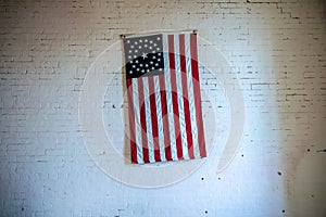 Old USA flag on a white brick wall