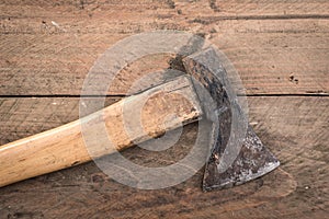 Old used axe on a wooden