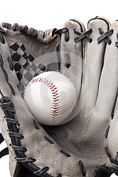 Old used baseball glove and ball isolated closeup