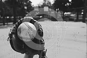 Old used baseball in mitt for game.