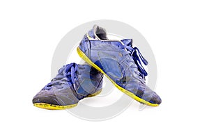 Old used blue worn out futsal sports shoes on white background soccer sportware object isolated