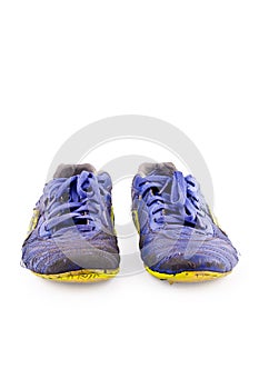 Old used blue worn out futsal sports shoes on white background soccer sportware object isolated