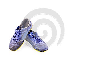 Old used blue worn out futsal sports shoes on white background soccer sportware object isolated