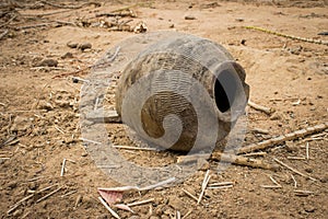 Old used and broken clay pot on the ground