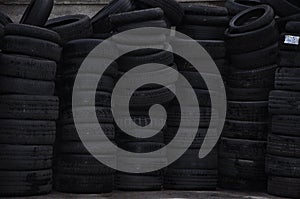 The old used car tires.Pile Of Many Old Used Tires Isolated. Wall of old car tires